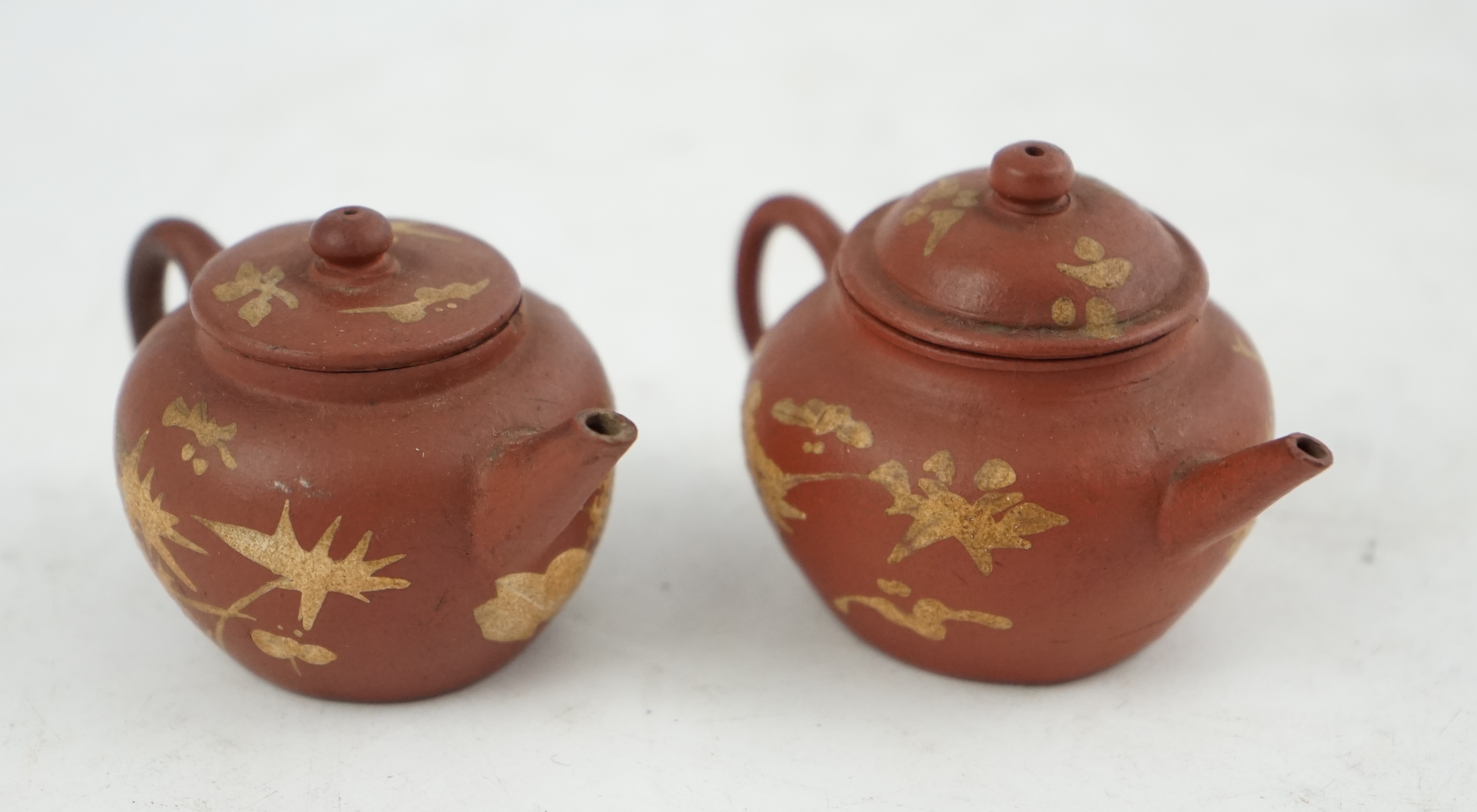 Two Chinese Yixing slip-decorated miniature teapots and covers, 18th/19th century
